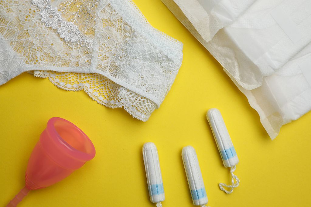 Various menstrual products including tampons, menstrual cups, menstrual sponges, and period underwear displayed together as a product assortment